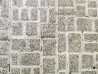 Textured gray cobblestone street background, a rustic stone block pavement pattern