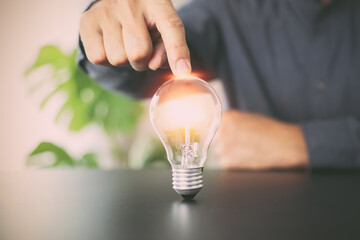 Close up hand choose light bulb or lamp with bright for human resources or leadership and...