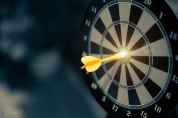 Arrow throw hitting center of Bulls eye target goal aim or dartboard shooting for strategy...