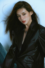 Female model in stylish black blazer with flowing hair.