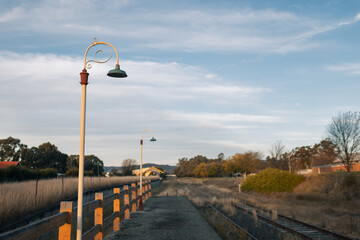 Old lamp posts along platform of abandoned railway station
