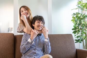 リビングのソファでヘッドロックしている若い女性