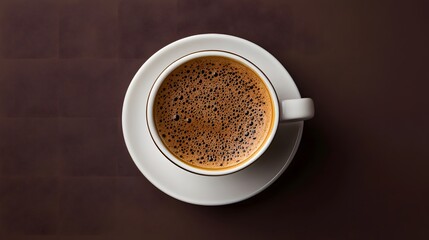 Fototapeta premium Overhead View of Dark Brown Coffee in White Cup on Dark Brown Background