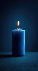 Single blue candle burning in dark room, nighttime meditation