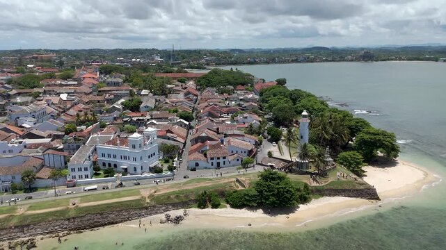 Aerial 4K drone footage of Galle Fort and coastline, Sri Lanka. Stunning views of historic Dutch Fort, lighthouse, beaches, and Indian Ocean&mdash;perfect for travel, tourism, and cultural projects