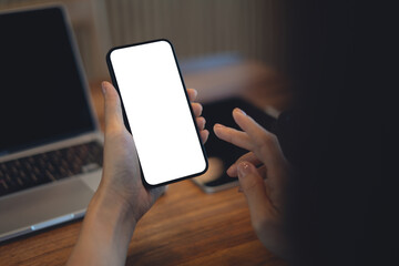 Mockup blank white screen mobile phone. Woman hand holding, using smartphone, online working at coffee shop, template for mobile app design, social media marketing, close up