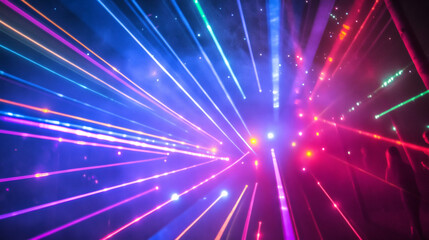 Fototapeta premium Colorful laser light beams radiating outward in a dark space.