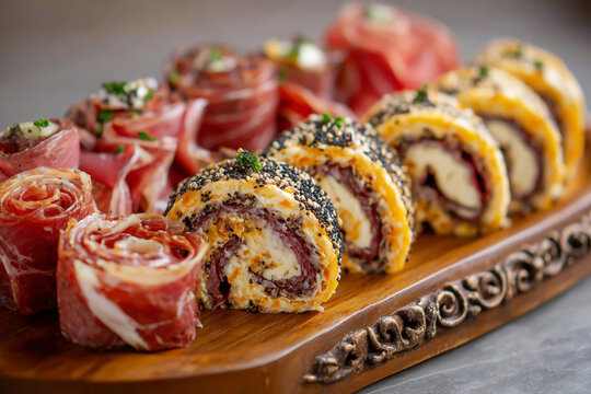 Gourmet appetizer platter with savory rolls and prosciutto pinwheels