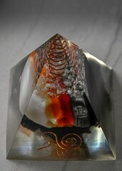 High resolution color image of a single isolated beautiful one of a kind hand made Orgone pyramid...