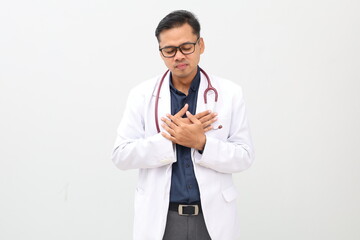 Asian adult male doctor standing wearing doctor's coat, stethoscope hanging around neck, smiling...