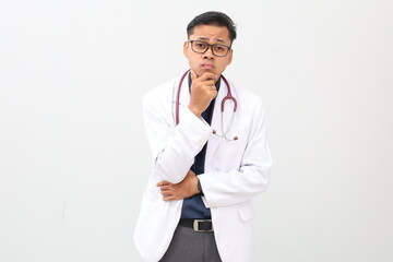 Asian adult male doctor standing wearing doctor's coat, stethoscope on neck, arms folded, finger on...