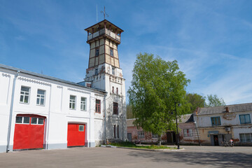 An ancient fire tower in the urban landscape on a sunny May day. Tutaev. Yaroslavl region, Russia