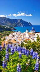 Obraz premium Coastal town nestled in hills. Vivid blue flowers frame the view