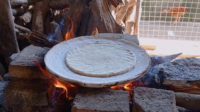 cooking tortillas on the comal over the fogon, kind of traditional mexican rural stove