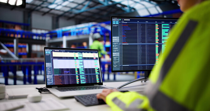 Warehouse Worker Uses Logistic Software To Manage Inventory And Orders