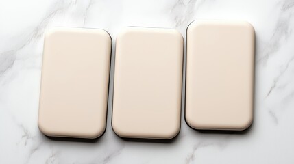 Set of three elegant cream-colored phone cases arranged on a marble surface