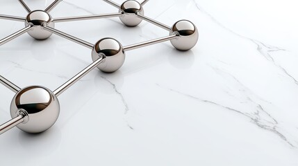 Metallic Spheres Connected by Thin Rods Creating a Network Structure on White Marble Surface