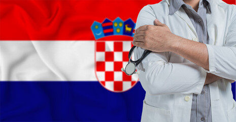 Doctor with stethoscope on arm with Croatia flag behind. National health system of Croatia, concept