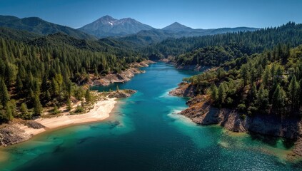 Aerial view of a pristine alpine lake, surrounded by lush forest and a mountain peak