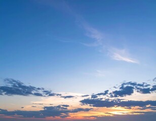 Serene sunset sky with wispy clouds and soft hues of orange and purple at the horizon
