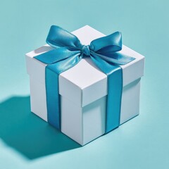 Obraz premium White gift box with teal ribbon bow, studio shot