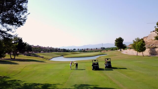 Golfer receiving advice from instructor on golf course
