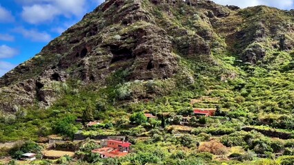 Experience a breathtaking view of beautifully terraced fields set against a stunning, majestic mountain backdrop