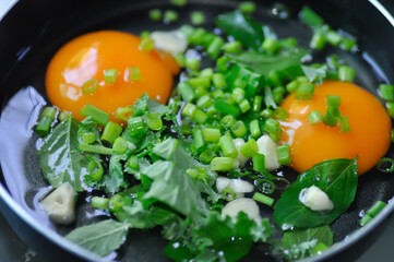 fried egg or sunny side up egg with vegetable topping before fry