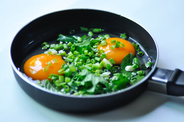 fried egg or sunny side up egg with vegetable topping before fry