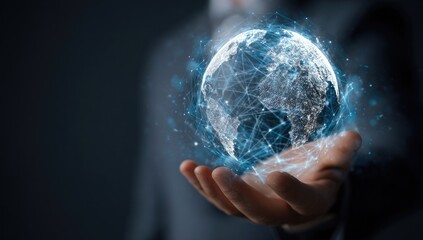 A hand, likely a business person's, hovers a holographic, interconnected Earth globe