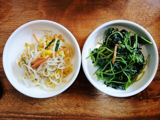 Fresh soybean sprout side dish (Kongnamul muchim) and short-fruit pimpinella salad (chamnamul muchim)- These can be served with many Korean dishes and is often used as a topping on Bibimbap