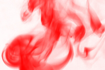 Vibrant crimson smoke swirls against a deep black background creating an abstract and energetic visual