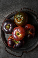 black prince tomatoes on a dark background