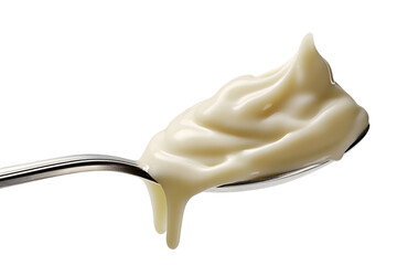 A close-up shot of a spoon with flowing of condensed milk. A trickle of milky goodness is gracefully dripping from the spoon