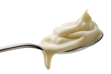 A close-up shot of a spoon with flowing of condensed milk. A trickle of milky goodness is gracefully dripping from the spoon