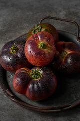 black prince tomatoes on a dark background