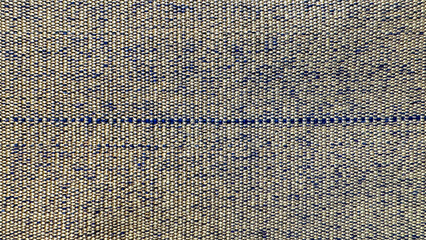 Background of a woven fabric texture in light beige and yellow tones with subtle dark specks and a horizontal thread line in the middle.
