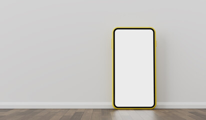 Yellow smartphone leaning against wall on wood floor background. 