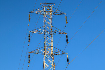 High voltage towers against blue sky background in Brazil