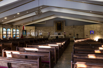 A devout christian middle aged woman In a church for praying, seeks guidance from her religious...
