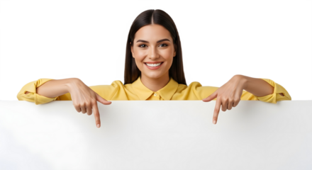 Woman in yellow shirt pointing down at a blank white sign with a smile on face