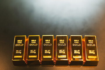 Gold bars rest on a company employee's desk, symbolizing the sound investment strategy of saving in...