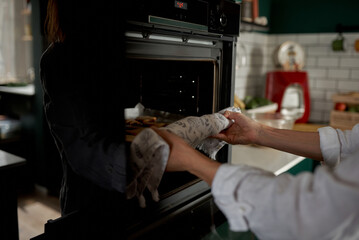 female hands holding a tray with fresh homemade gingerbread