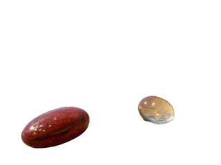 Smooth polished stones with reflective surfaces isolated on a transparent background glass beach