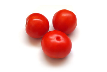 Tomato vegetables isolated on white background. Natural, organic and fresh whole tomatoes. Delicious and healthy ingredient for salads and seasonal food.