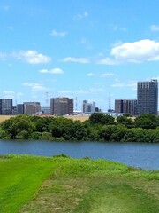 Fototapeta premium 夏の土手から見る江戸川と対岸の三郷中央駅付近のマンション群風景