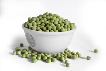 Green peas in white bowl isolated on white backgrounds.