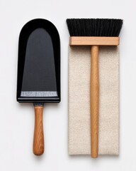 Black scoop and brush resting on a cream-colored cloth