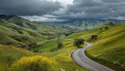 Winding road through a valley, dramatic sky