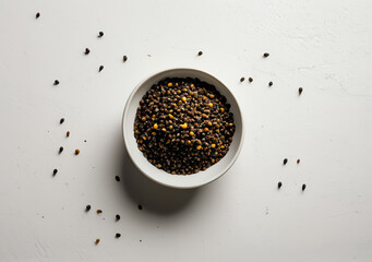Top view of black belkuga lentils in white bowl.